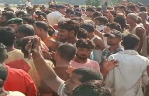 गुस्साई भीड़ पुलिस पर पत्थरबाजी करते हुए