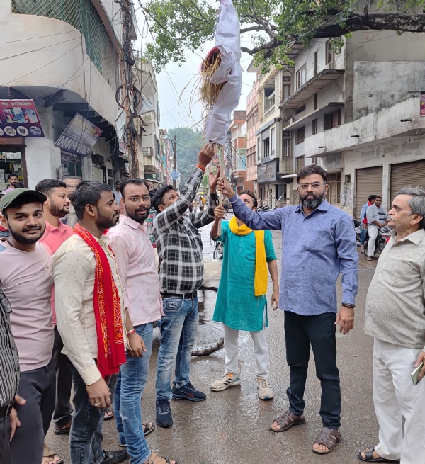 नगर के डंकीनगंज स्थित चिनिहवां इनारा पर  ऊर्जा मंत्री एके शर्मा का पुतला फूकते व्यवसायी।