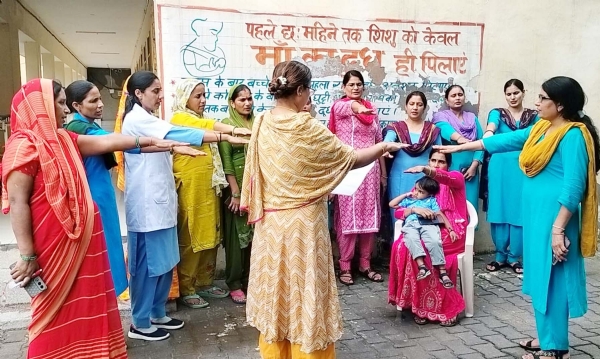गुरुग्राम में स्तनपान सप्ताह के तहत महिलाओं को शपथ दिलातीं स्वास्थ्यकर्मी।