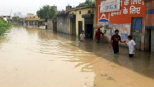 बसंतपुर में भरे पानी के बाद निकलते लोग