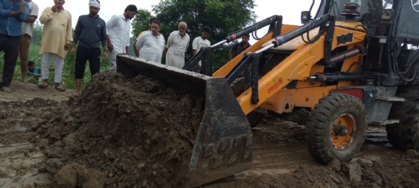 पानीपत में बाढ़ से निपटने के लिए गांव पत्थर गढ़ में खड़ी जेसीबी मशीन