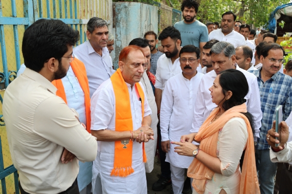 महापौर प्रवेश वाही निरीक्षण के दौरान अधिकारियों से बात करते हुए।