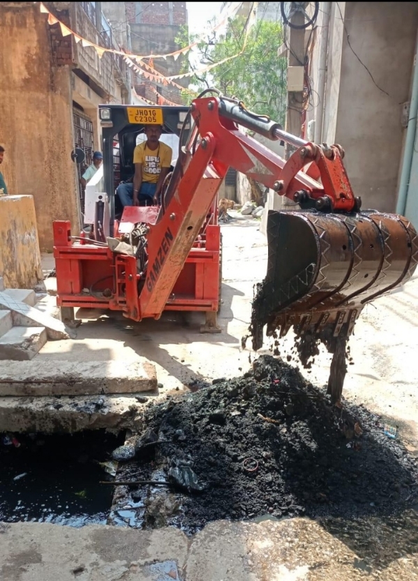सफाई कार्य में लगाया गया स्किड लोडर (मिनी जेसीबी) मशीन की तस्वीर सफाई कार्य में लगाया गया स्किड लोडर (मिनी जेसीबी) मशीन की तस्वीर